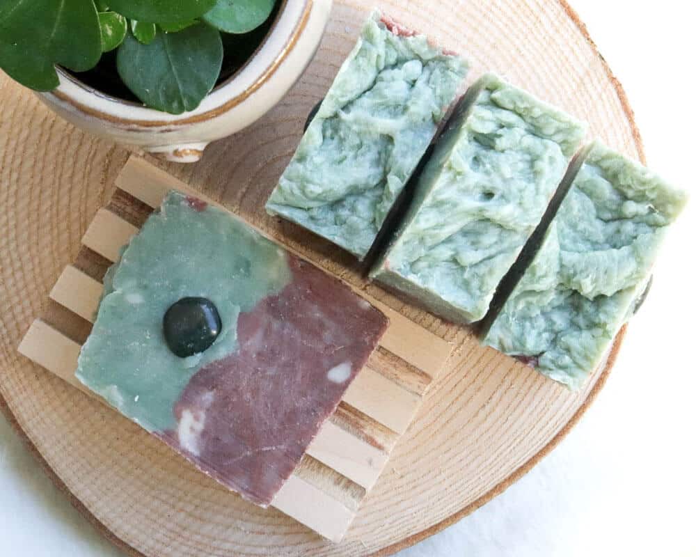 hand made green gemstone soap purple on natural wooden holder