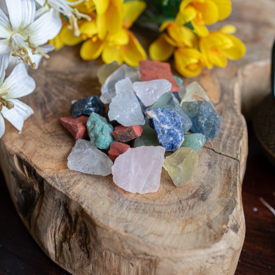 raw gemstones on wood with flowers