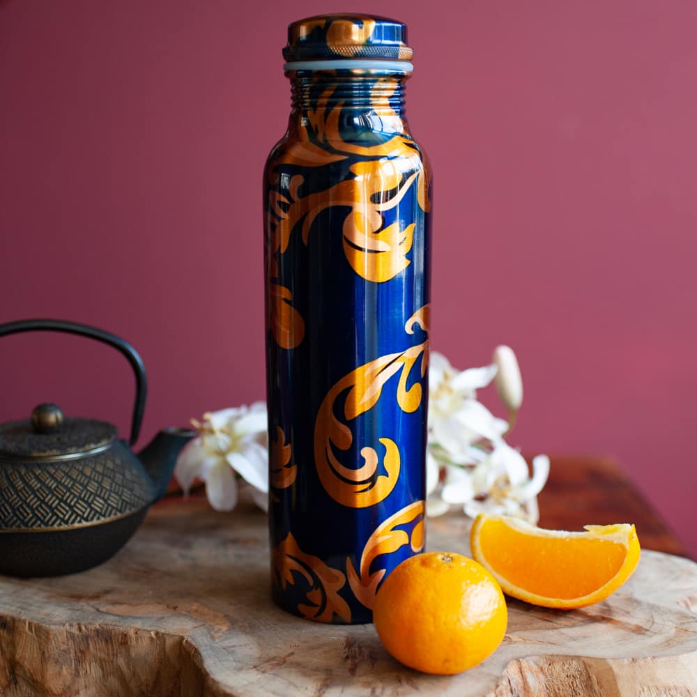 blue and yellow painted copper water bottle with lemon
