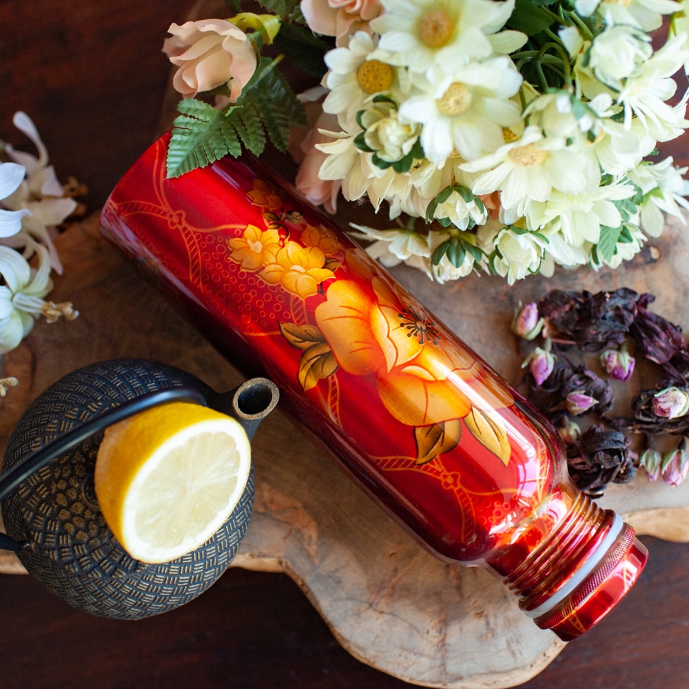 red painted copper water bottle flowers