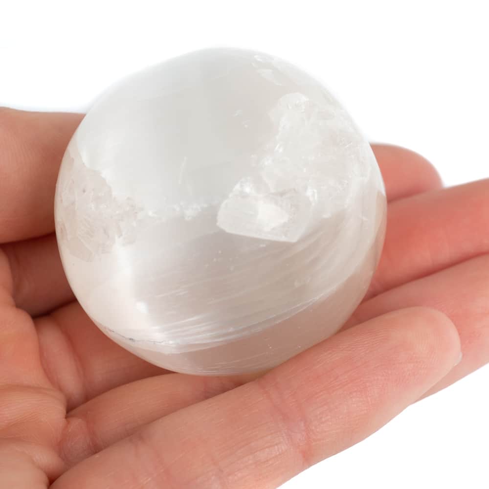 rock crystal sphere in hand white crystal