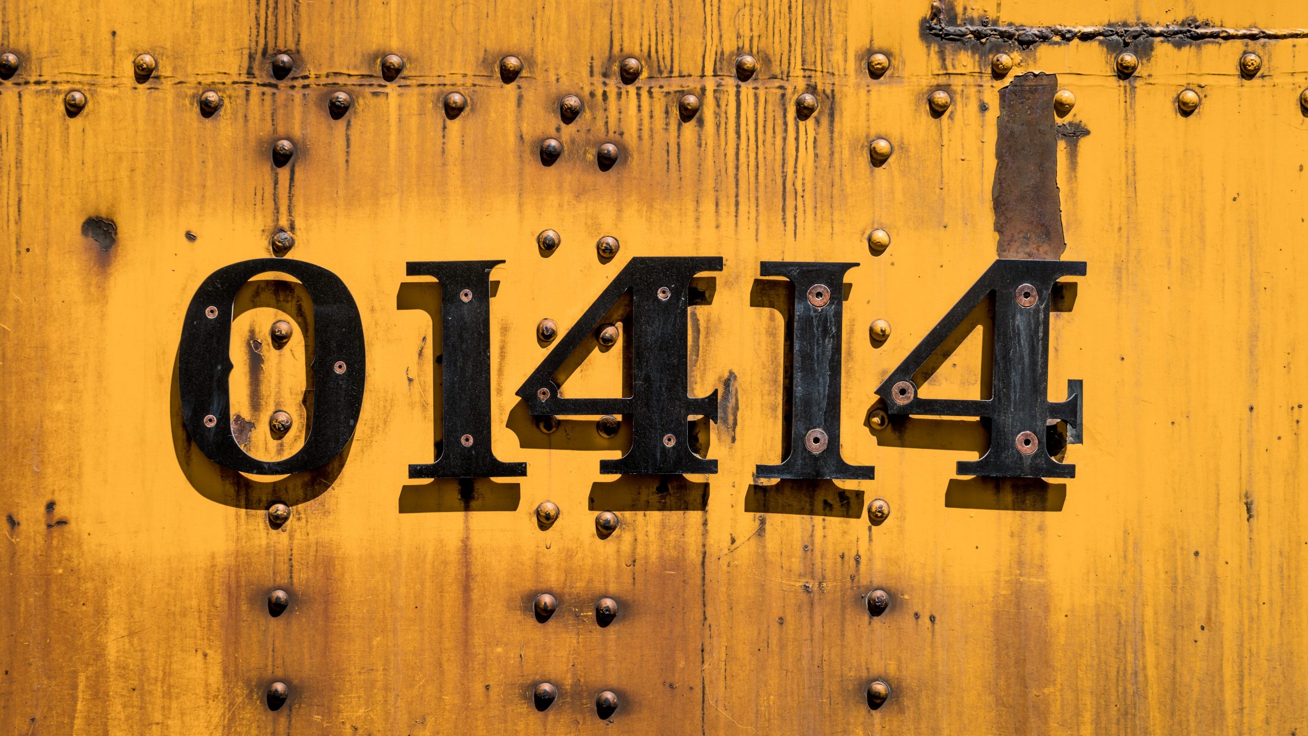 yellow metal wall with black number 1414