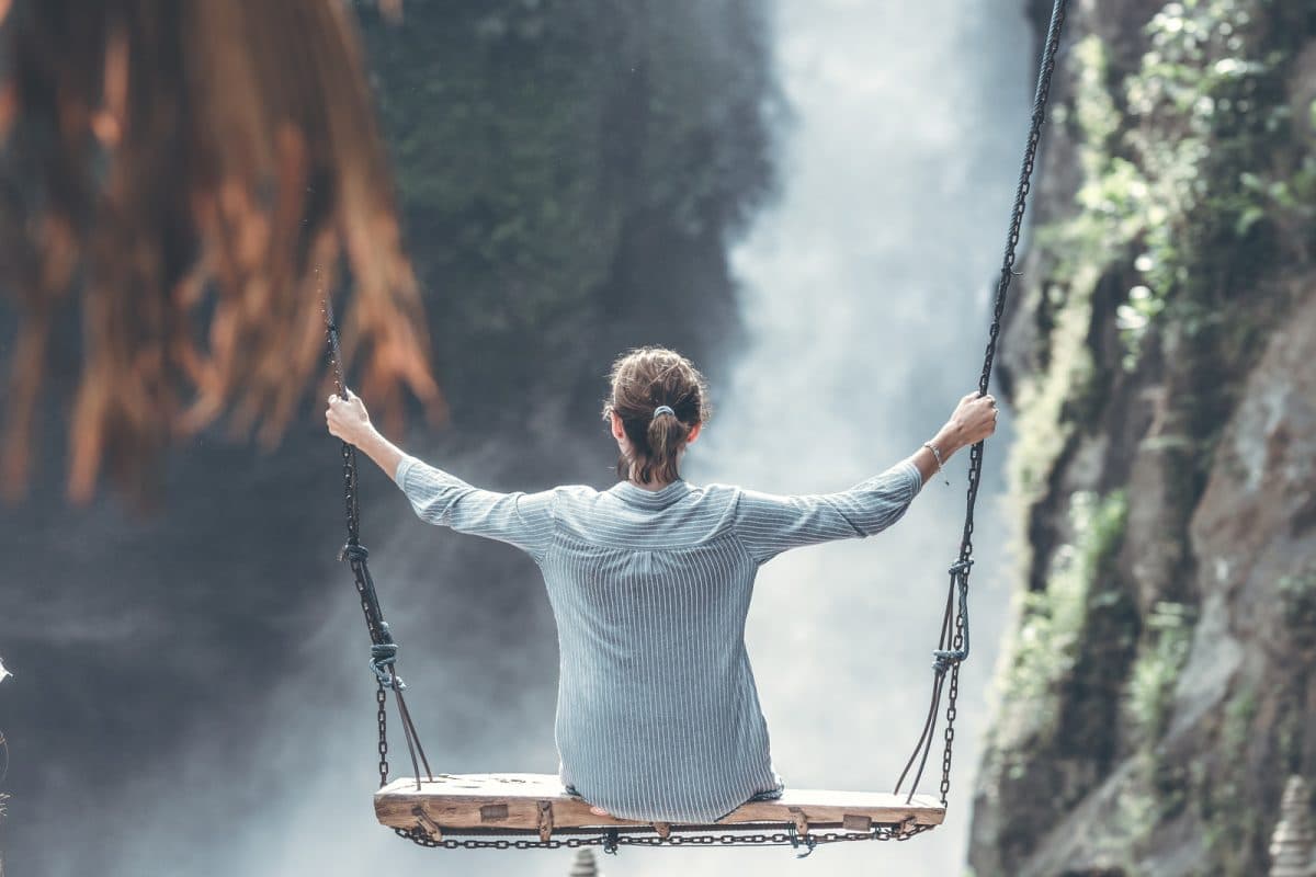 woman on swing in mountains