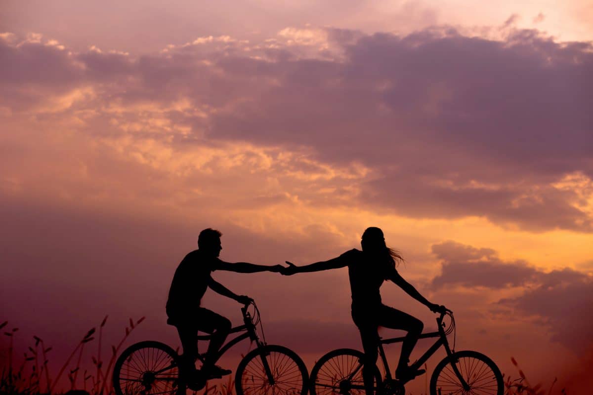 couple biking sunset