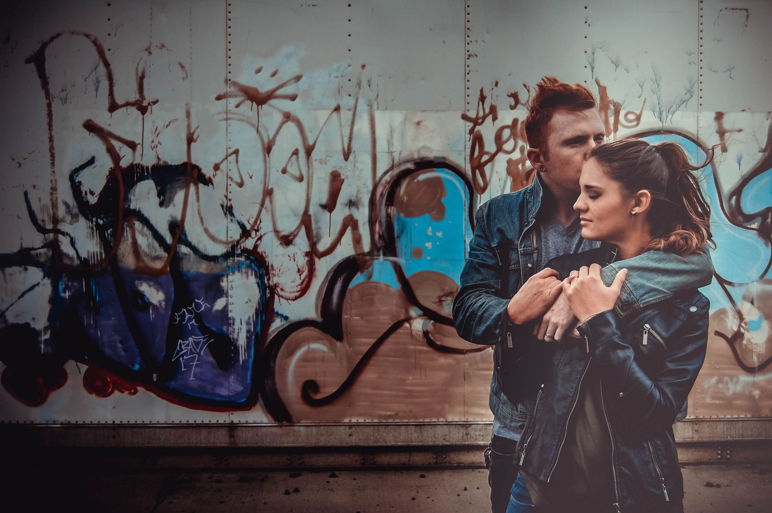 creative couple in front of grafitti