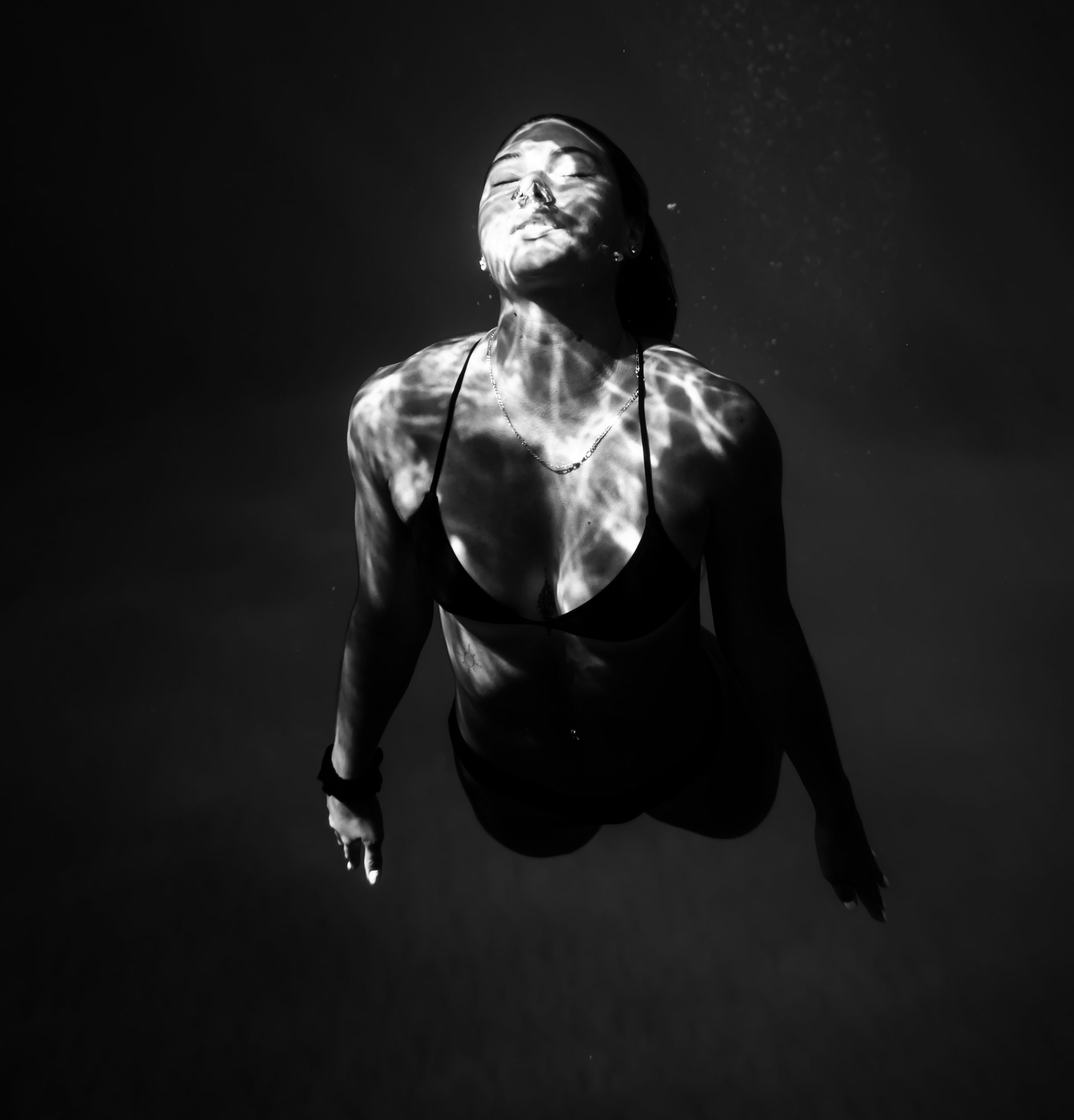 woman swimming under water