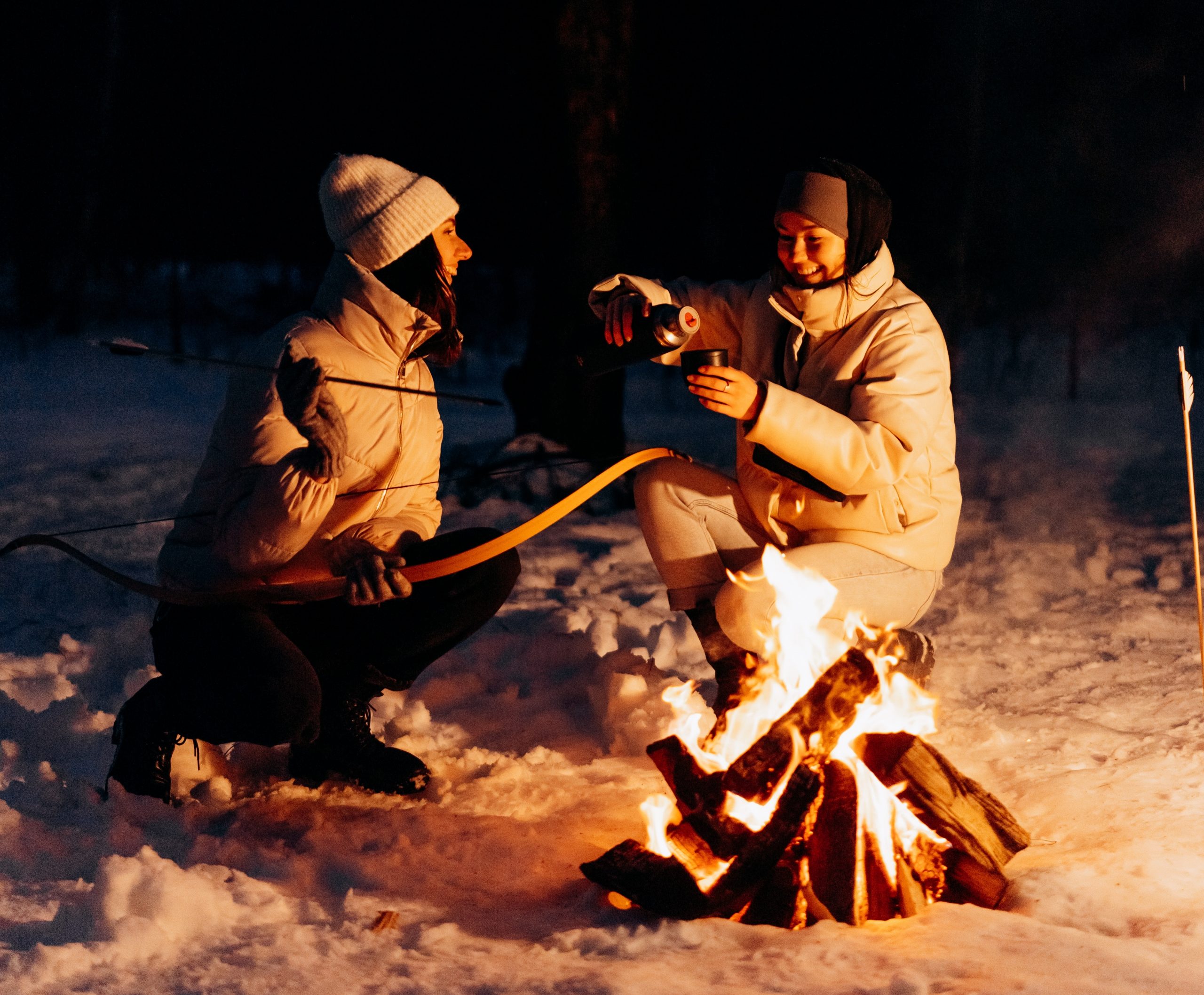 archer campfire in snow with friend