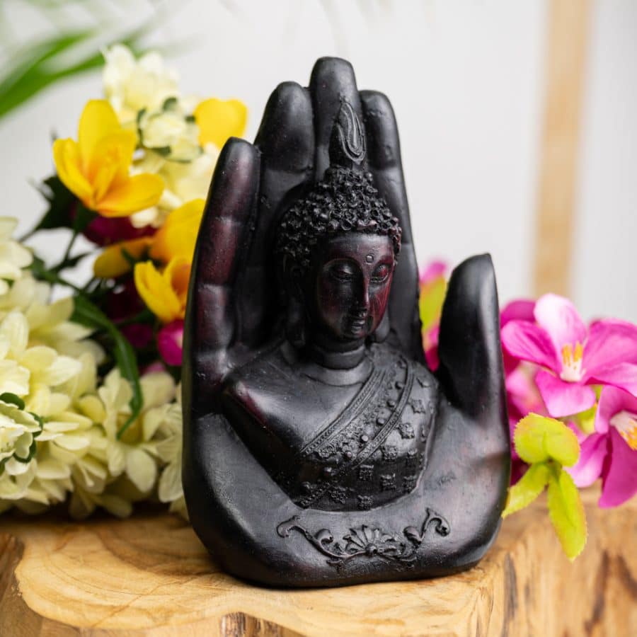 buddha head in hand sculpture dark resin