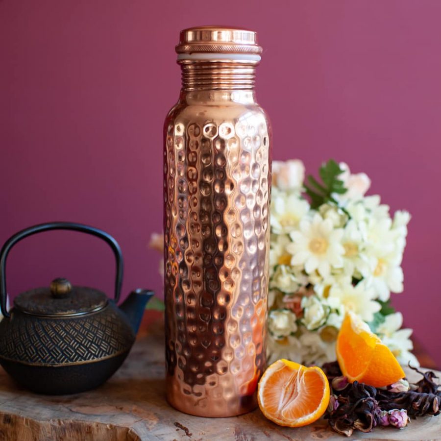 hammered copper water bottle with oranges