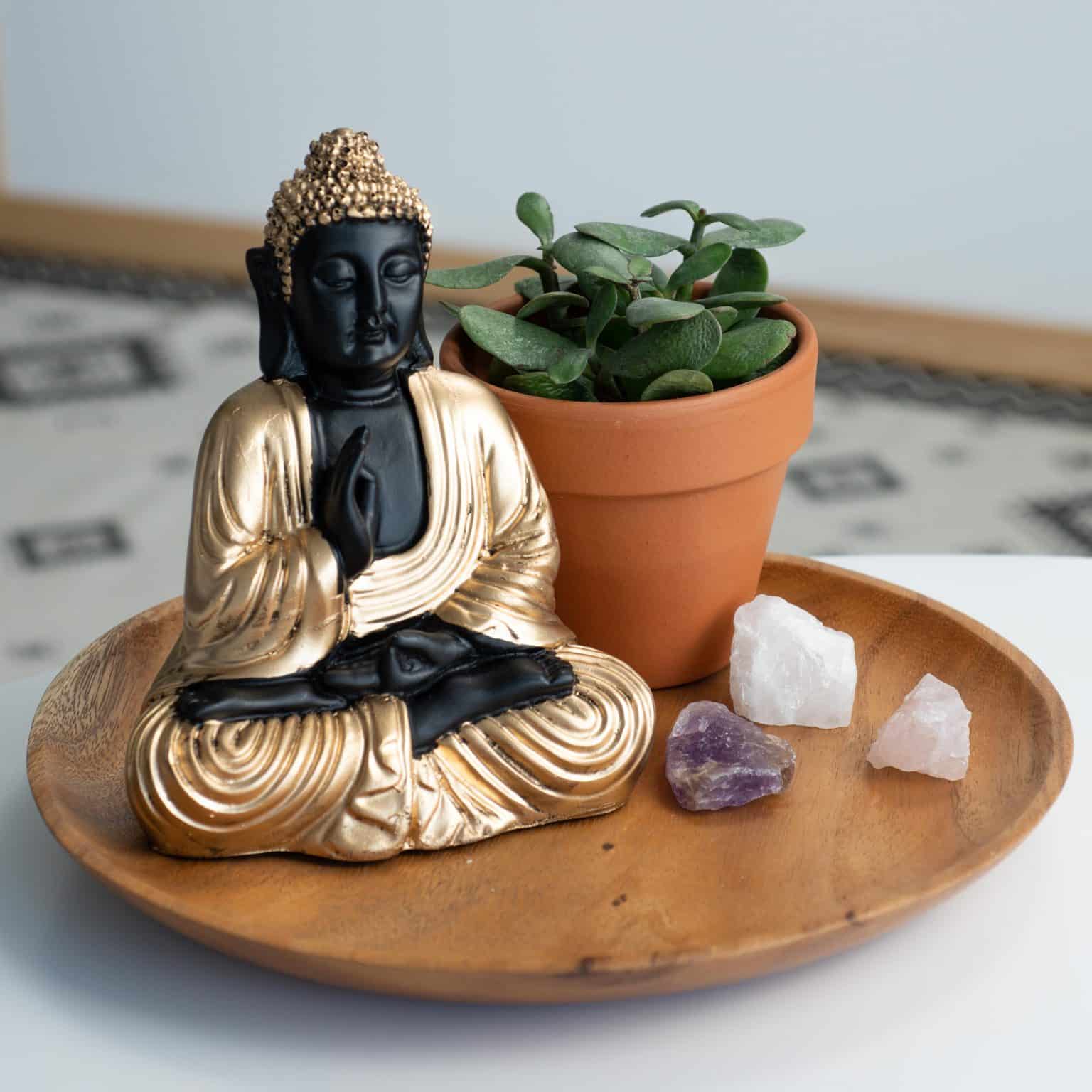 meditating buddha in half lotus pose with golden triangle gemstones crystals