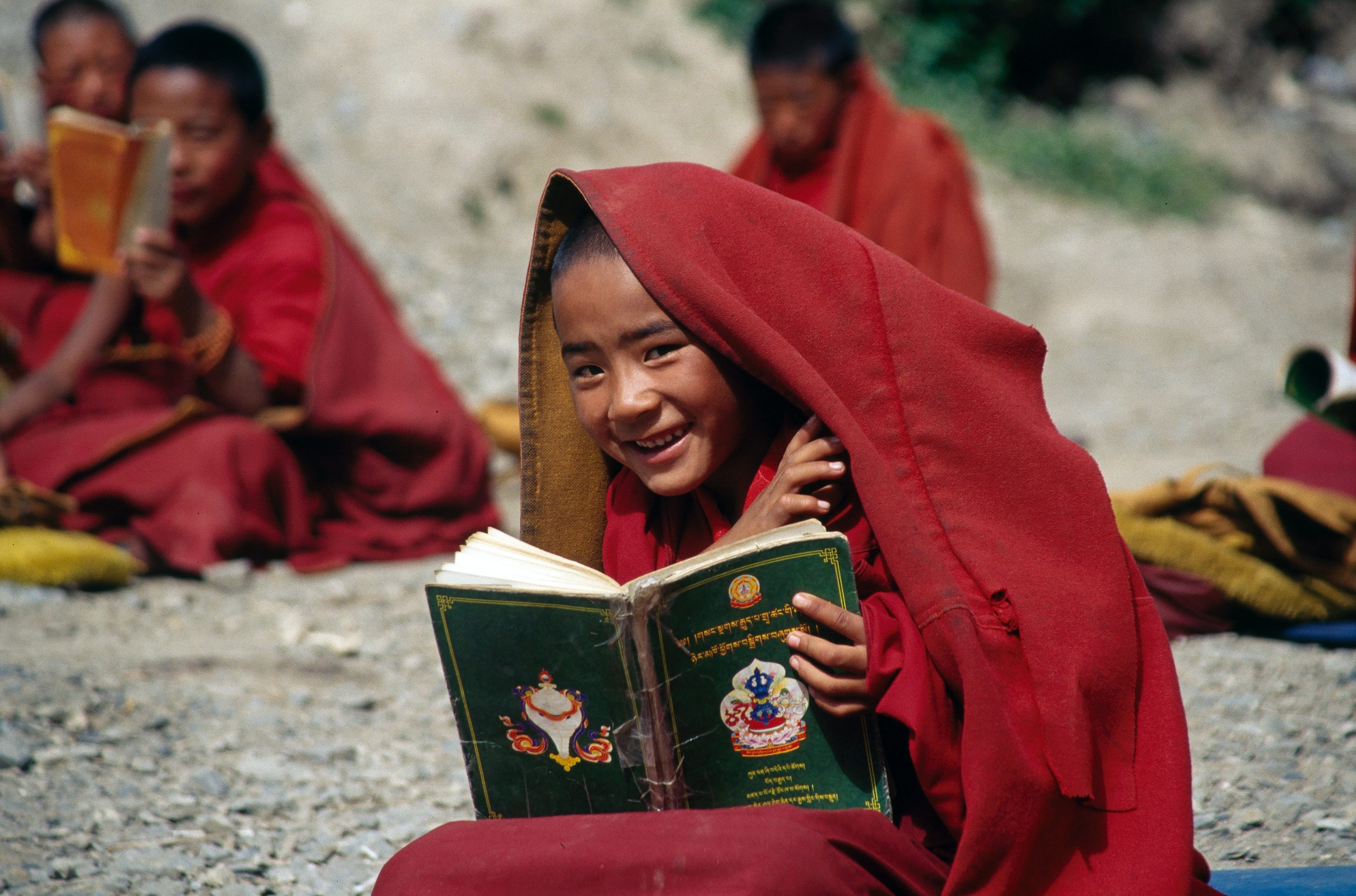 young Buddhist monk boy reading