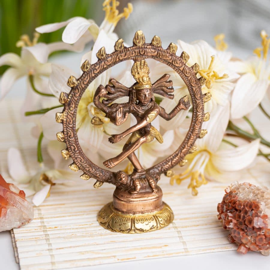 shiva nataraja brass statue with white flowers and gemstones