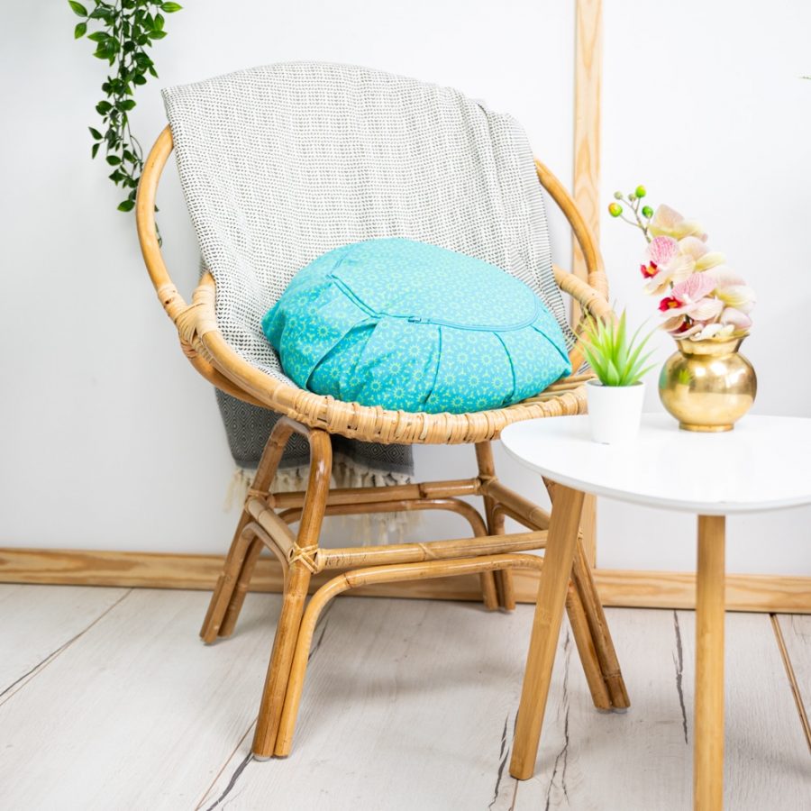 rotan chair, grey woven blanket and turquoise spiru round meditation cushion