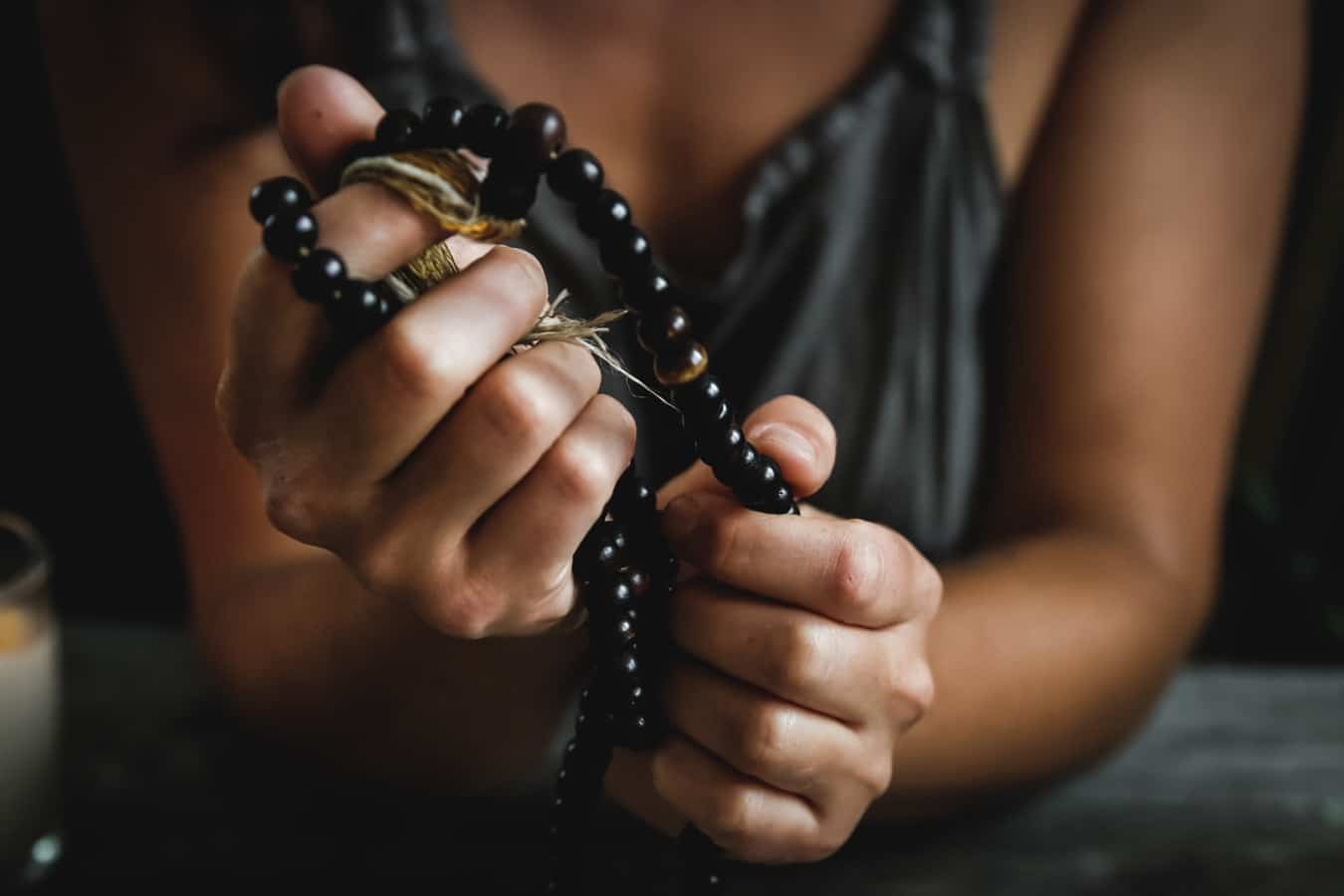 dark wood mala beads in hands