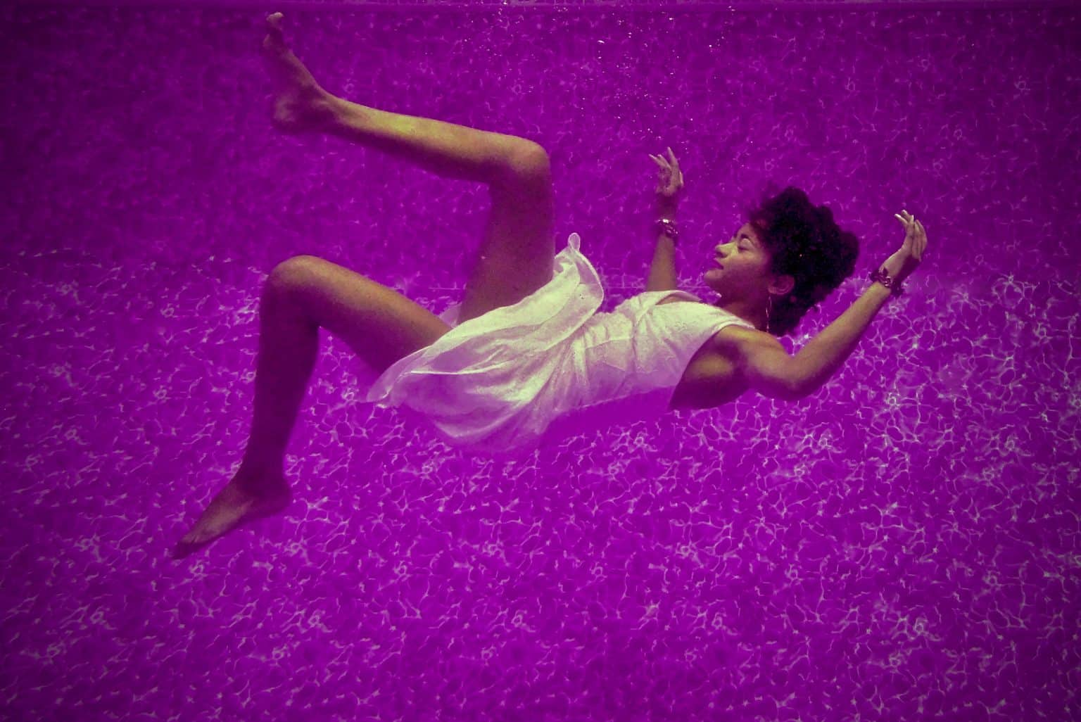 woman falling backward through purple dream