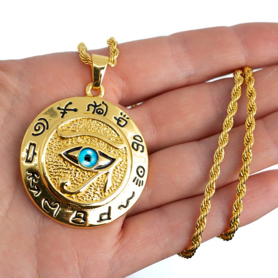 gold eye of Horus amulet with hieroglyphics 