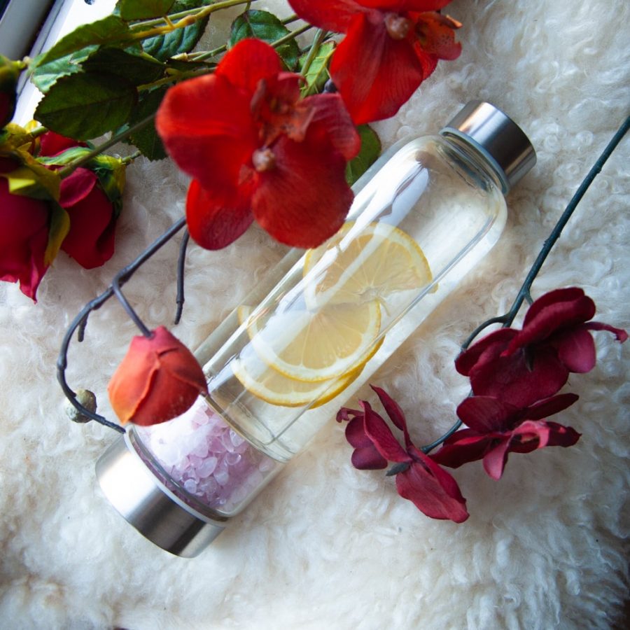 gemstone water bottle rose quartz with lemon and red flowers