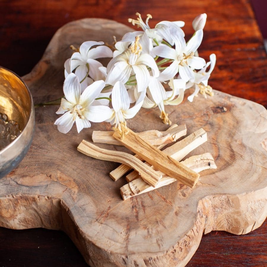 palo santo sticks white flowers and singing bowl