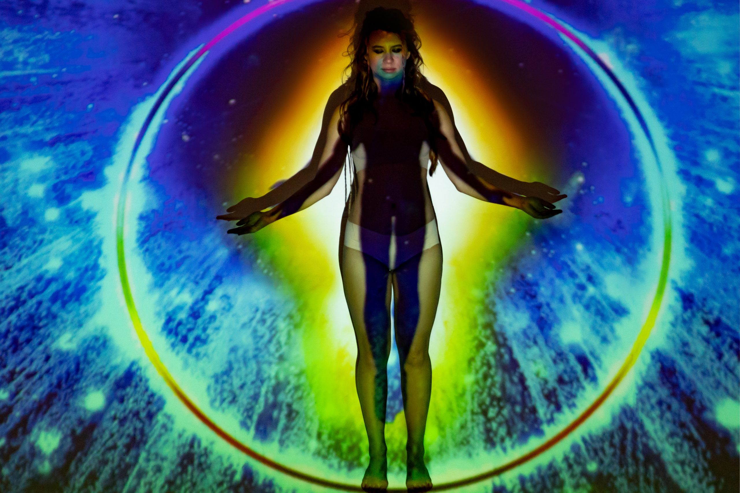 aura color projection on wall over woman