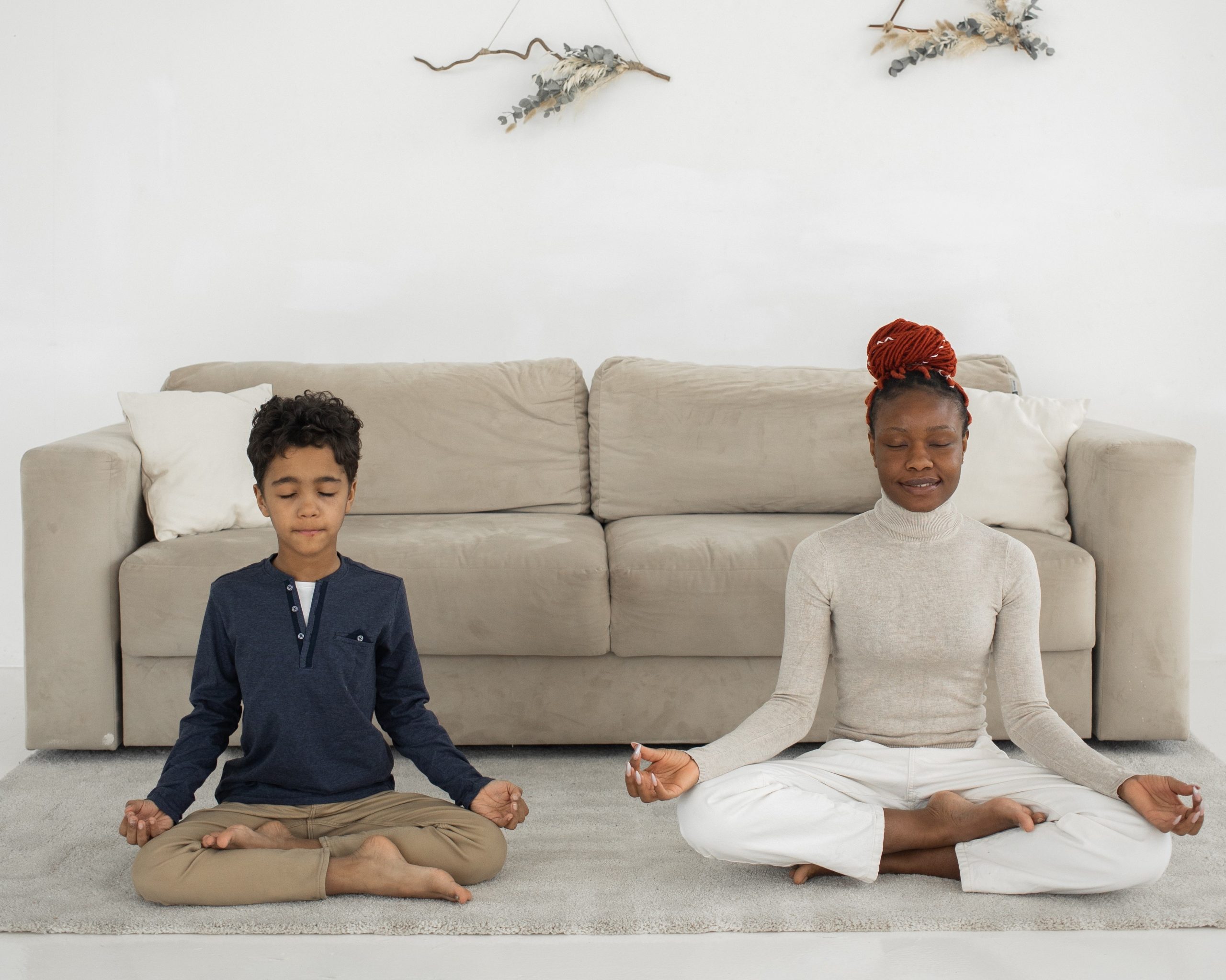 mother and son doing yoga in living room